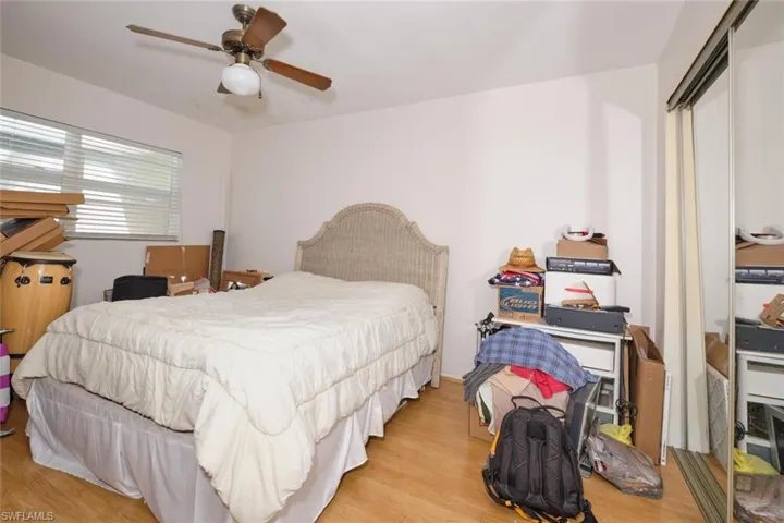 Apartment - Primary Bedroom with light wood-type flooring and ceiling fan