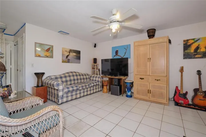 Apartment - Living room featuring ceiling fan and light tile