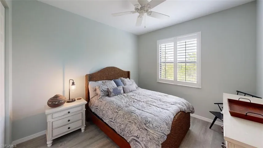 Bedroom with ceiling fan and hardwood / wood-style flooring