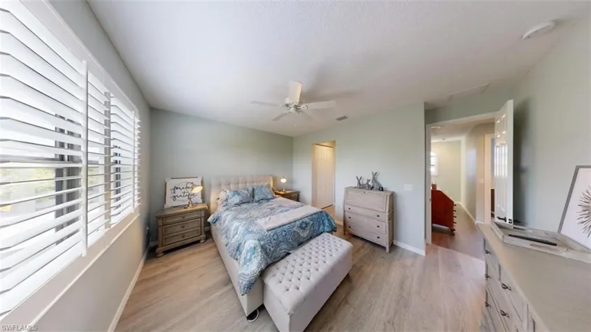 Bedroom featuring light hardwood / wood-style floors and ceiling fan