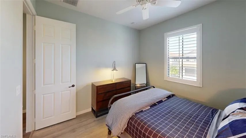 Bedroom with light wood-type flooring and ceiling fan