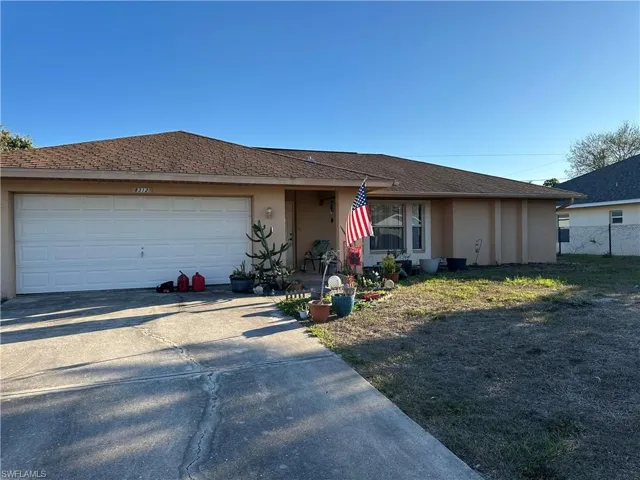 Single story home with concrete driveway, stucco siding, a garage, and roof with shingles