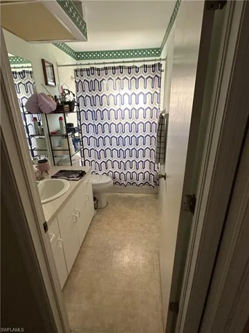 Bathroom with vanity and light floors