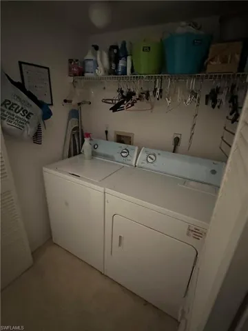 Laundry area featuring washing machine and clothes dryer and light floors