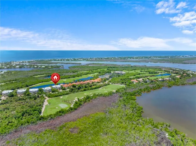 Bird's eye view of a golf club and a nearby body of water