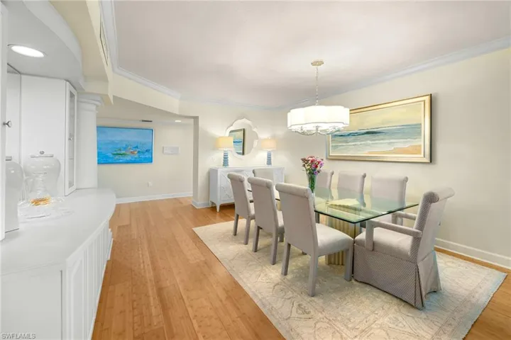 Dining space with light wood-style floors and ornamental molding