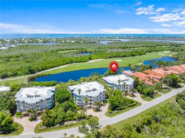 Aerial view of a golf course and a nearby body of water