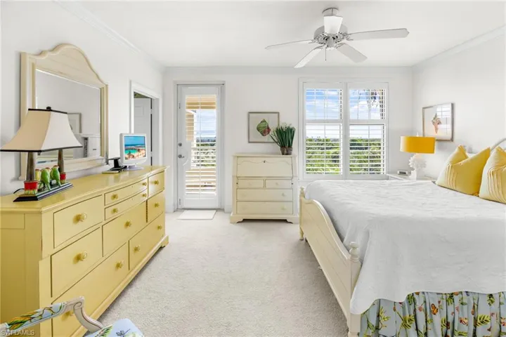 Bedroom with access to outside, light colored carpet, ceiling fan, and ornamental molding