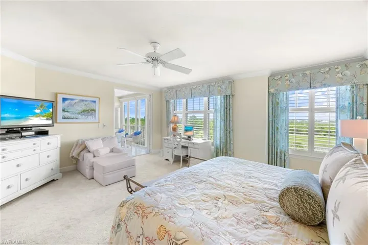 Bedroom with access to outside, crown molding, light carpet, and a ceiling fan