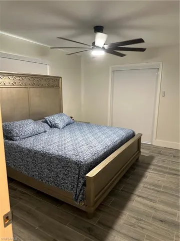 Bedroom with wood tiled floors and ceiling fan