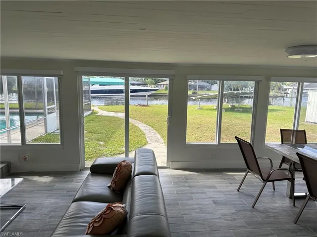 Sunroom / solarium featuring a water view