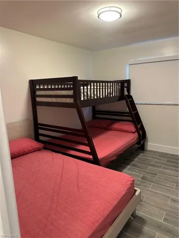 Bedroom with wood finish floors and baseboards
