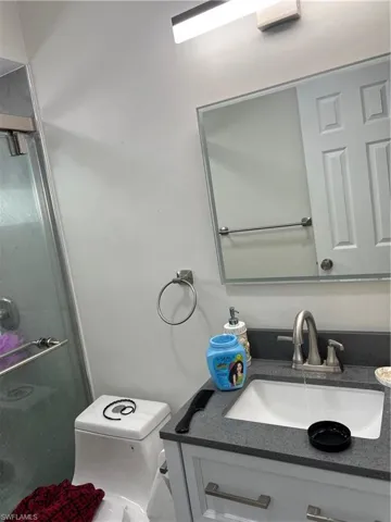 Bathroom featuring vanity and a shower with shower door