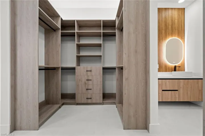 Custom wood-finish closet system featuring integrated shelving and drawer storage