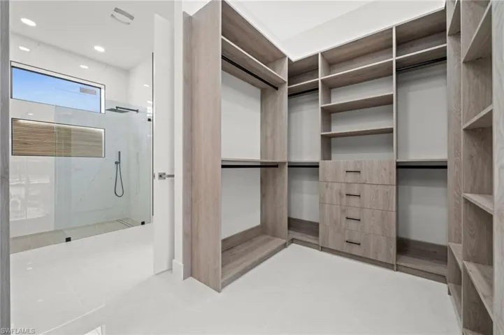 Custom closet system featuring integrated shelving, hanging rods, and drawer storage
