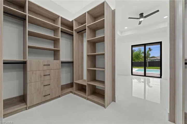 Custom wood-finish closet system featuring integrated drawers and hanging rods