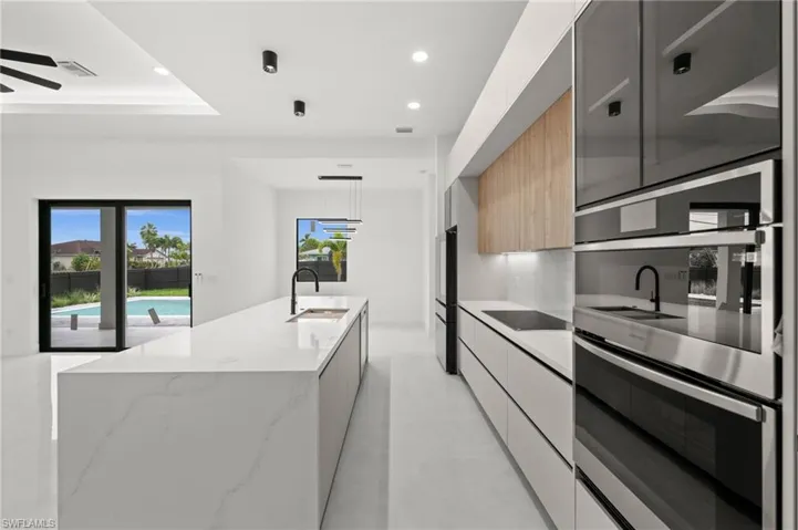 Modern kitchen with a substantial island featuring a matte black faucet and under-mount sink