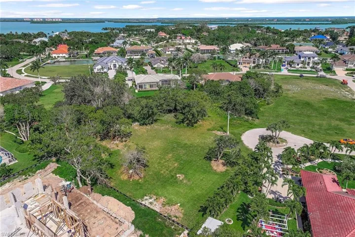 Aerial perspective of suburban area featuring a nearby body of water