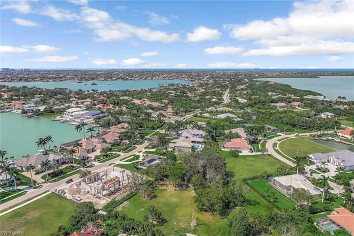Aerial perspective of suburban area featuring a large body of water