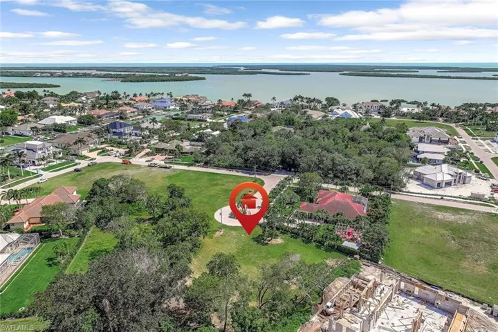 Aerial perspective of suburban area with a nearby body of water