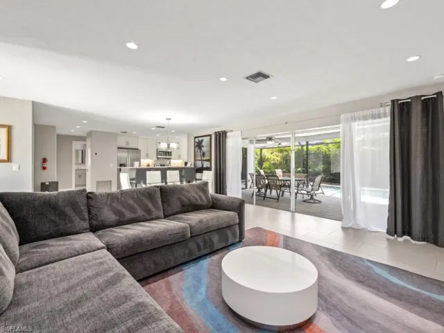 Living room with healthy amount of natural light and recessed lighting