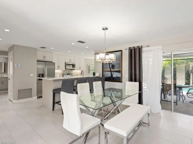 Dining space featuring a chandelier and recessed lighting