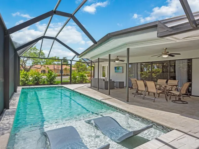 Outdoor pool with a patio, a sunroom, ceiling fan, and glass enclosure