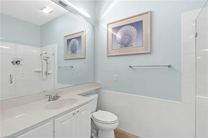 Full bath with walk-in shower, separate toilet and vanity sink.
