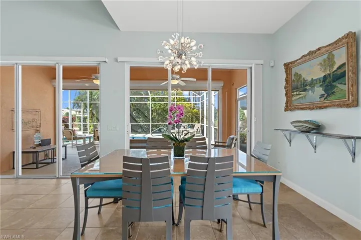Dining area with sliders, designer lighting, and high end furnishings.