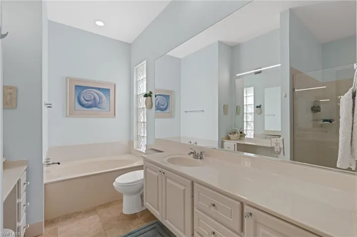 Plenty of natural light, vanity, large countertop and soaking tub.