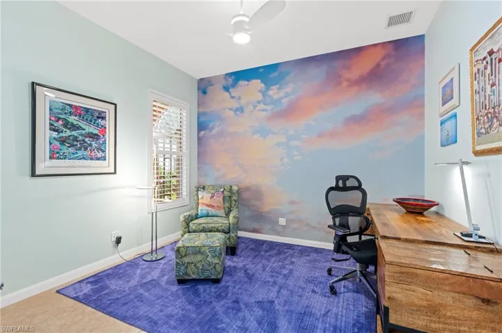 Bedroom, den, or second office with large mirrored closet, French doors and ceiling fan.