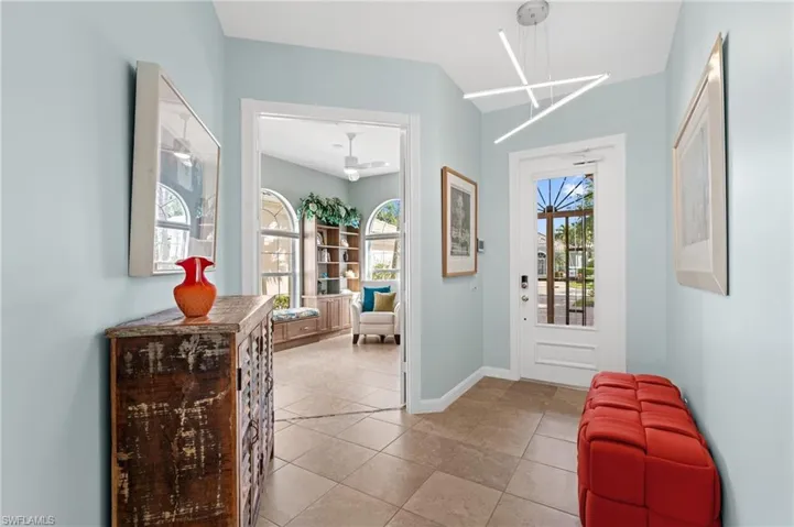 Foyer with designer light fixture and tile floors.