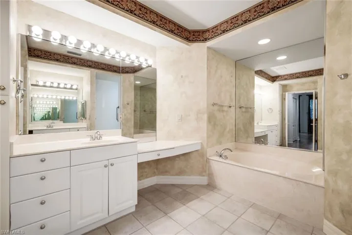 Dual sinks, soaking tub, and large walk in shower