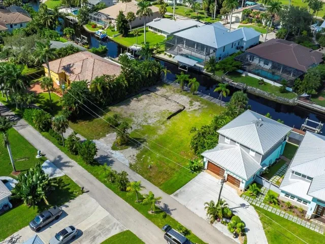 Aerial view of residential area featuring a nearby body of water