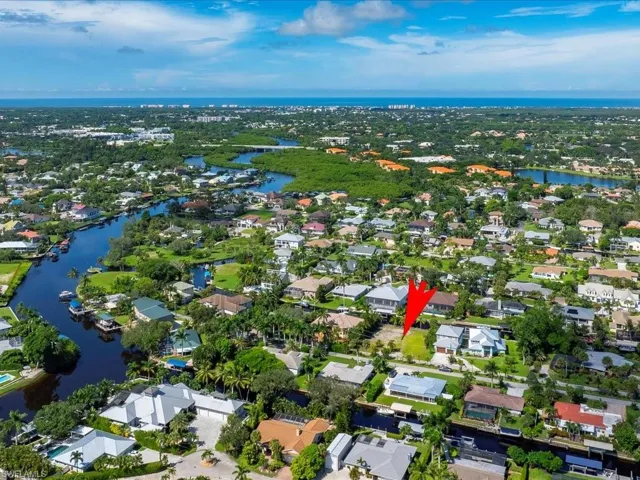 View of property location with a large body of water and nearby suburban area