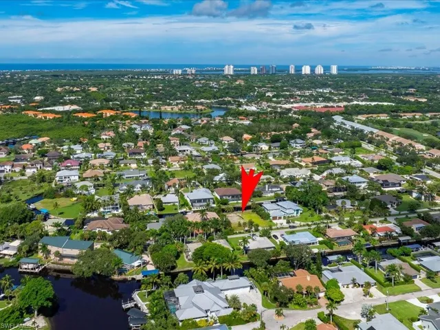 View of property location featuring a nearby body of water and nearby suburban area
