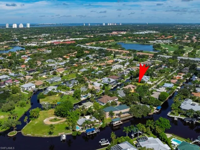Aerial overview of property's location with a large body of water and nearby suburban area