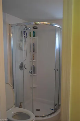 Bathroom featuring a stall shower and toilet
