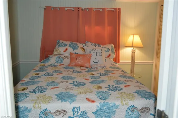 Bedroom featuring wallpapered walls