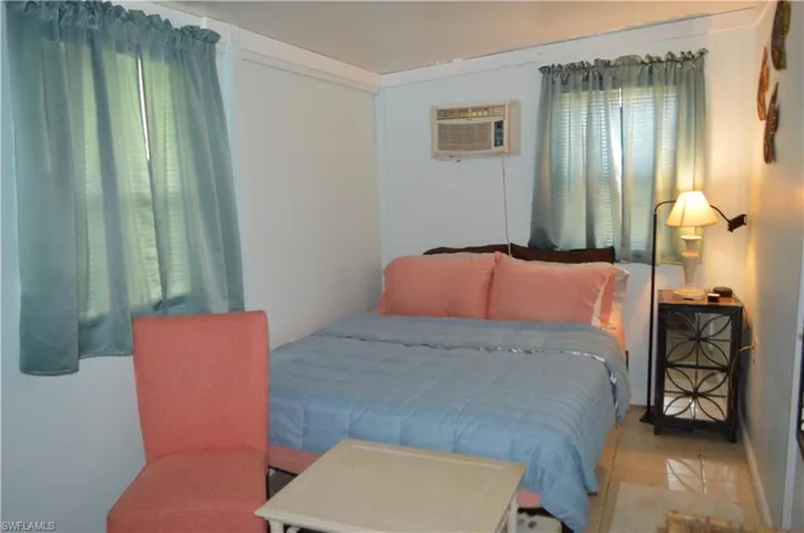 Bedroom featuring a wall mounted AC and tile patterned flooring