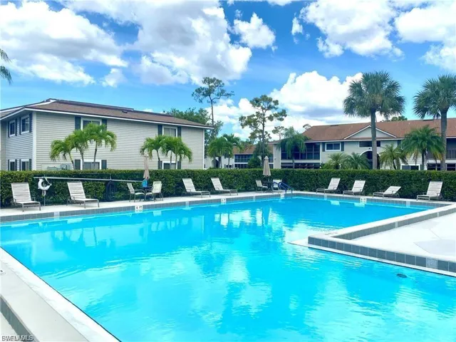 Community pool with a patio