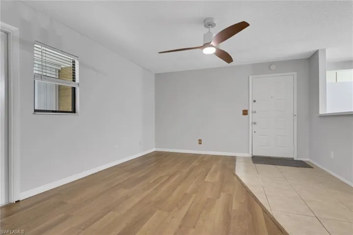 Entryway with light wood-style floors, a ceiling fan, and a textured ceiling