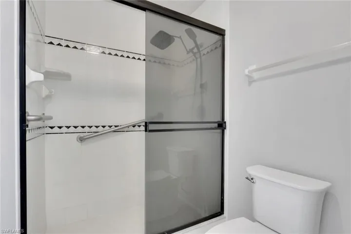 Bathroom with toilet and a stall shower