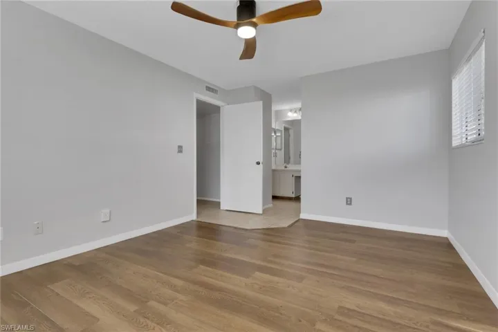 Unfurnished room with ceiling fan and light wood-style flooring