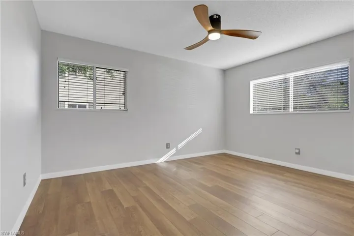 Empty room with light wood-type flooring and a ceiling fan