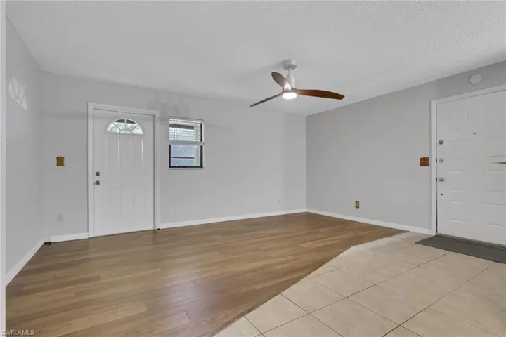 Entrance foyer featuring light wood-type flooring, a textured ceiling, and ceiling fan