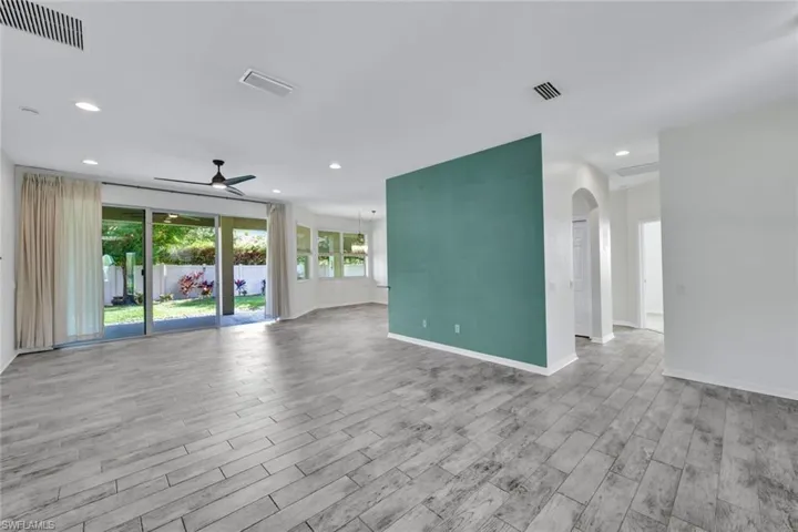 Empty room with light hardwood / wood-style floors and ceiling fan