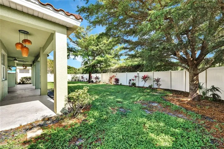 View of yard featuring ceiling fan and a patio