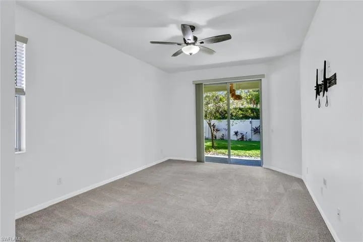 Unfurnished room featuring ceiling fan and light colored carpet