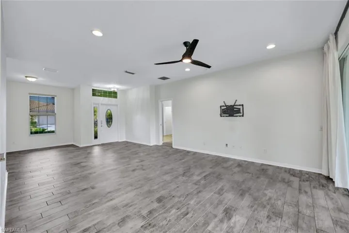 Unfurnished living room featuring light hardwood / wood-style floors and ceiling fan